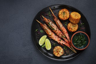 Langoustines on skewers, shrimp kebab, with fried corn, spices and herbs, homemade, no people