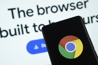 Chrome logo is displayed on a smartphone screen, with the chrome website visible on a computer