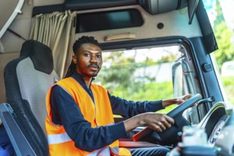 View from inside the vehicle of an african male young worker driving a distribution lorry