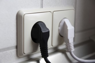 Double socket outlet, mains plug, black, white, electricity, household, Two different coloured