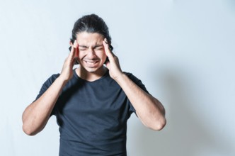 Headache and migraine concept. Suffering man with migraine massaging head isolated