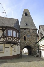 Historic clock tower and half-timbered house with oriel, landmark, town gate, town tower,