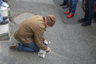 Pupil polishes and cleans a stumbling stone to commemorate the Night of Broken Glass on 9 November