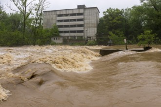 Symbolic image extreme weather, global warming, climate change, flood, flooded weir in Remseck an