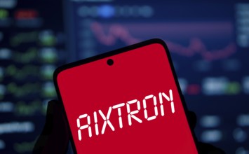 AIXTRON logo is displayed on smartphone. Aixtron SE is a European multinational technology company.