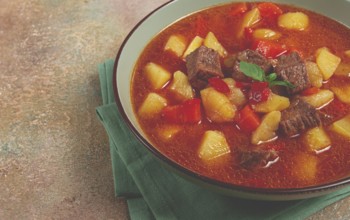 Meat goulash, with potatoes and carrots, sweet pepper, traditional Hungarian soup, homemade, no