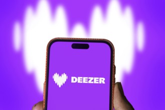 deezer logo is displayed on smartphone. Deezer is a French music streaming service