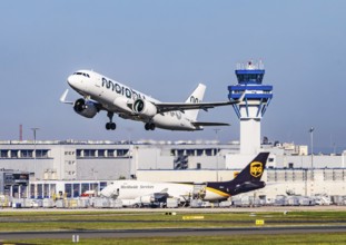 Cologne Bonn Airport with tower. Aircraft taking off. Aircraft registration number ES-MBA, Marabou