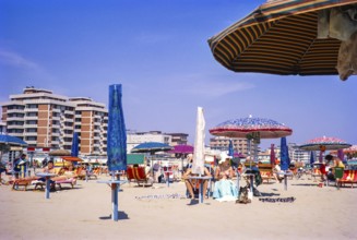 People sunbathing on the sandy beach of Rimini, Emilia Romagna region, Italy 1969