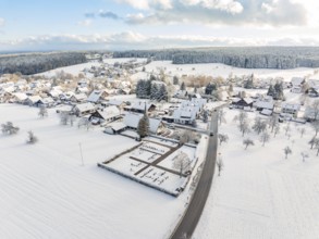 Snow-covered village with church and surrounding fields and forests, Oberreichenbach, Black Forest,