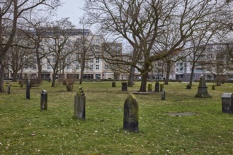 Old St. Nikolai Cemetery, historic cemetery, old gravestones, lawn, bare winter trees, cloudy,