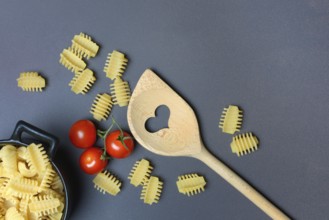 Cooking spoon with heart and Italian pasta, Radiatori variety