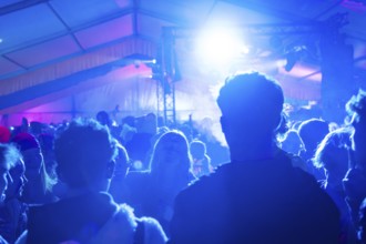 Party in full swing with blue lights and dancing people, carnival, Schlagerkuchen Donzdorf,