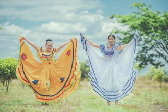Portrait of smiling girls in national folk costume in a field. Women wearing traditional Nicaraguan