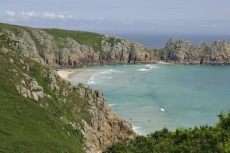 Felsen und Strand an einer Küste mit klarem Wasser und blauen Himmel, Porthcurno, St Levan,