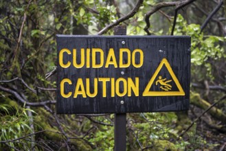 Warning sign Cuidado Caution, Attention danger of slipping, in the forest, Poás National Park,