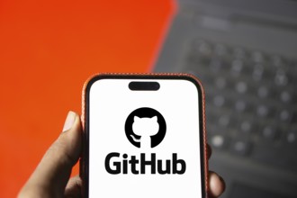 github logo is displayed on smartphone. GitHub is a proprietary developer platform
