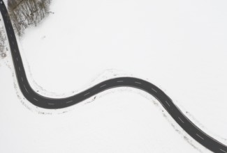 Aerial view of a winding country road in the snow, between Eppendorf and Leubsdorf, Central Saxony,