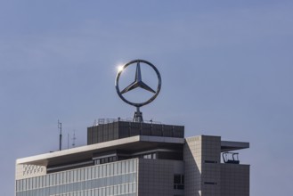 Mercedes star with sun star. Building at the headquarters of Mercedes-Benz Group AG in