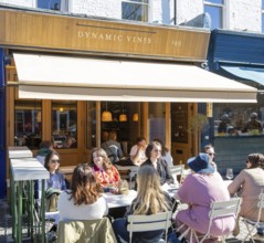 People sitting outside Dynamic Vines wine shop, East Dulwich, London, England, UK
