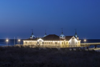 Restaurant on Ahlbeck Pier, Seebrücke Ahlbeck illuminated at dusk in the Baltic Sea on Usedom