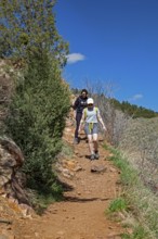 Idledale, Colorado - Hikers on the Bruin Bluff Trail in Lair o' the Bear Park. The park is part of