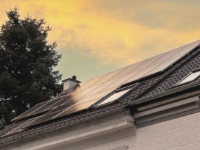 Solar panels at sunset on the roof of a detached house in Düsseldorf, Germany
