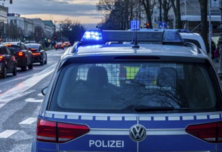 Police vehicles with flashing lights switched on, special operation at the Berlin State Library,