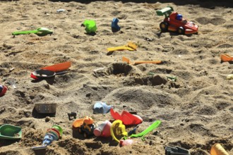 Playground, sandpit with plastic toys, vehicles, shovel