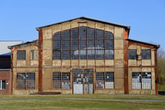 Abandoned factory with large windows and rusty structures, Ilseder Hütte, Ilsede, Peine district,