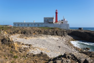 Lighthouse on rocky coast with clear sky and sea view, Farol do Cabo Raso, São Brás de Sanxete