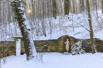 Sculpture of a woman and wall, winter in the landscape park of Dittersbach Castle,