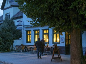 Country inn Unterspreewald, illuminated windows, twilight, passers-by, Schlepzig, Brandenburg,