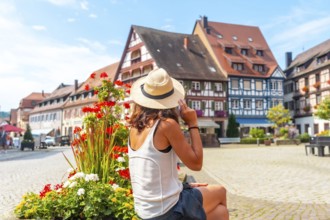 A female tourist in the old town of Gengenbach in the Black Forest, Germany