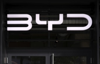 Logo in front of showroom, sales exhibition of the car brand BYD Build Your Dreams, e-vehicles,
