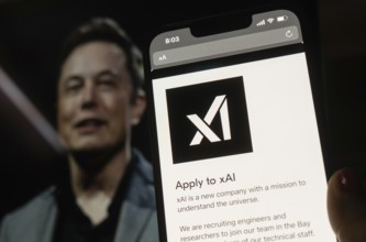In this photo illustration, A person browses website of xAI, displayed on a mobile phone, Elon Musk