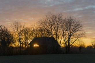 Sunset, sky burning, evening sun shining through a window of a house, house on the Dijkweg,