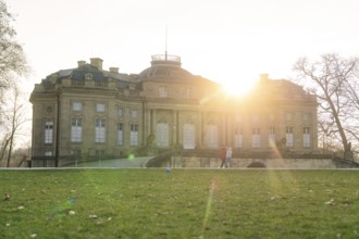 The historic palace at sunrise, surrounded by green lawns and trees, Domäne Monrepos, Ludwigsburg,