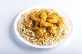 Rice with chicken curry sauce with cashew isolated on white background. close up