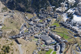 Blick auf eine kleine Stadt im Gebirgstal von Andorra mit verschneiten und grünen Flächen. Klar