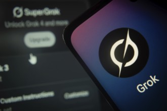 SuperGrok upgrade interface with Grok app prominently displayed on smartphone