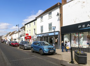 Shops and shoppers in North Street, Sudbury, Suffolk, England, UK - Peacocks, Caffe Nero