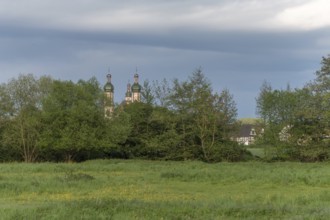The baroque Saint-Maurice church in Ebersmunster surrounded by meadows in spring. Bas Rhin, Alsace,