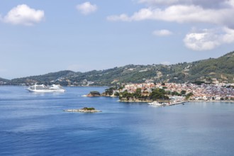 Skiathos town with cruise ship holidays by the sea on the Mediterranean island of Skiathos, Greece