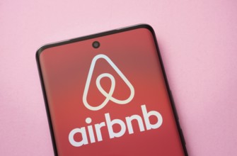 Airbnb logo is seen on a smartphone