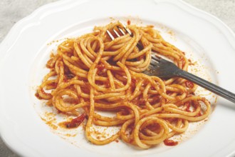 A plate with leftover spaghetti bolognese, no people