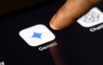 In this photo Illustration a person taps Gemini App icon on a tablet device on 24 May 2025 in New