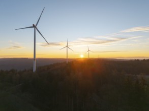 Tranquil landscape with wind turbines at sunrise over wooded area, wind farm, Rems Valley,