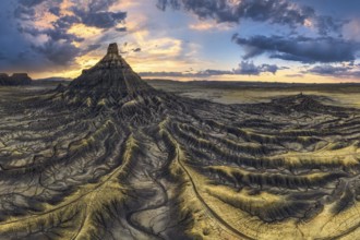 Spectacular aerial view of Factory Butte at sunset with vivid sky colors and intricate erosional