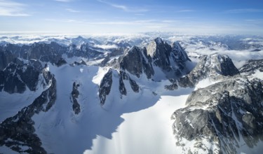Rock cliffs, snow and ice, epic mountains with glaciers, aerial view, Alaska Range, Denali National